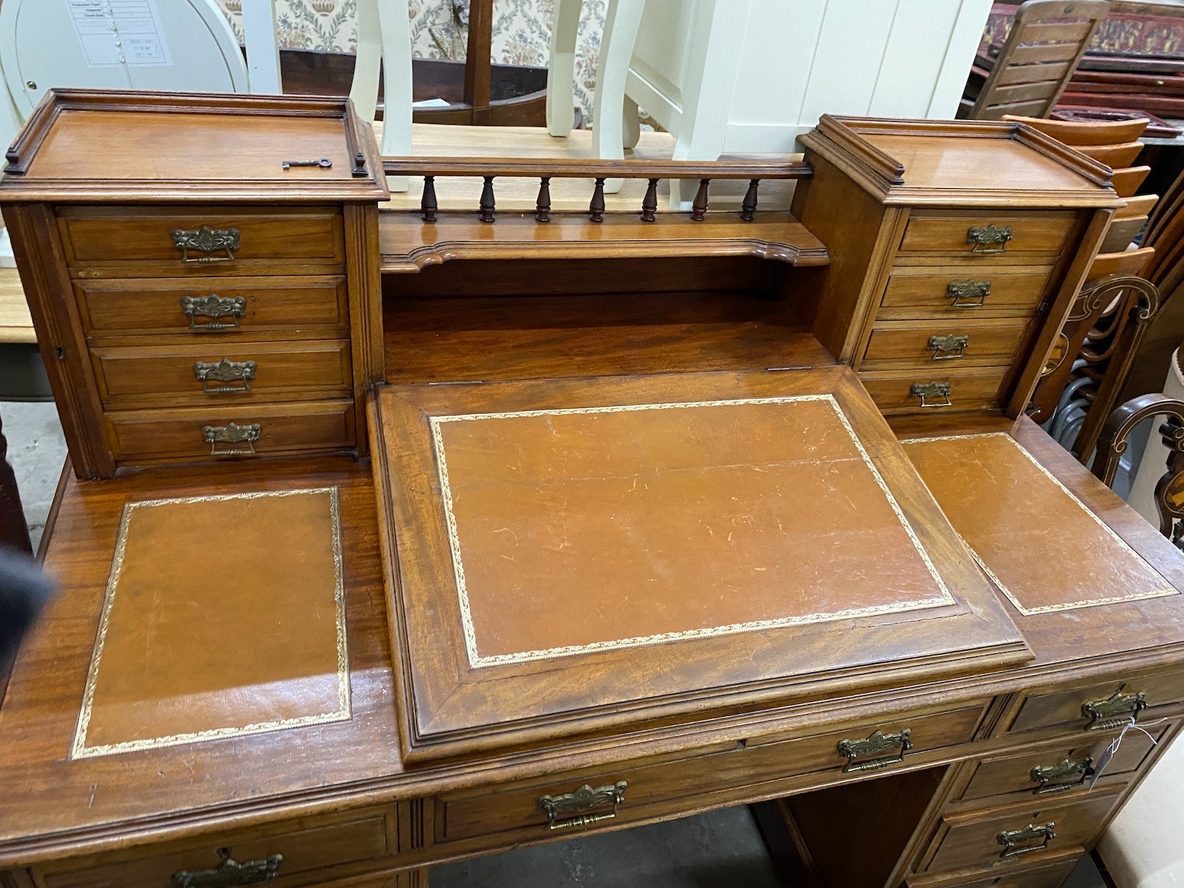 A late Victorian mahogany pedestal desk with hinged slant front, width 137cm, depth 73cm, height 113cm